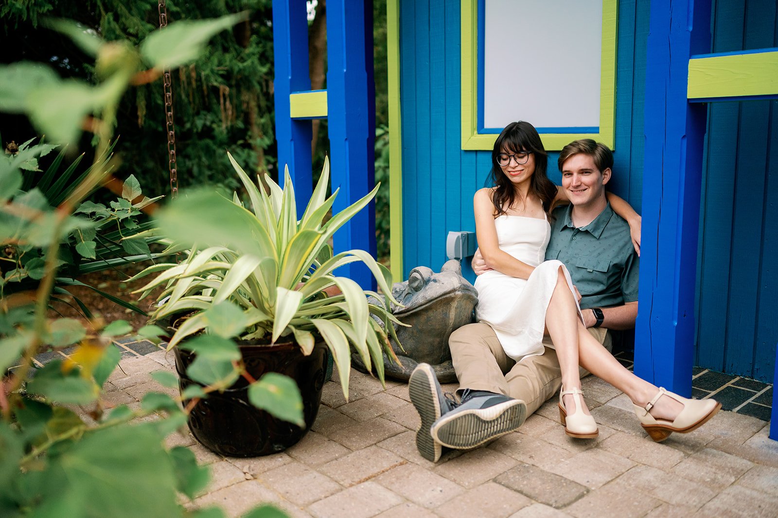 Lucian and Ngara sitting by a frog